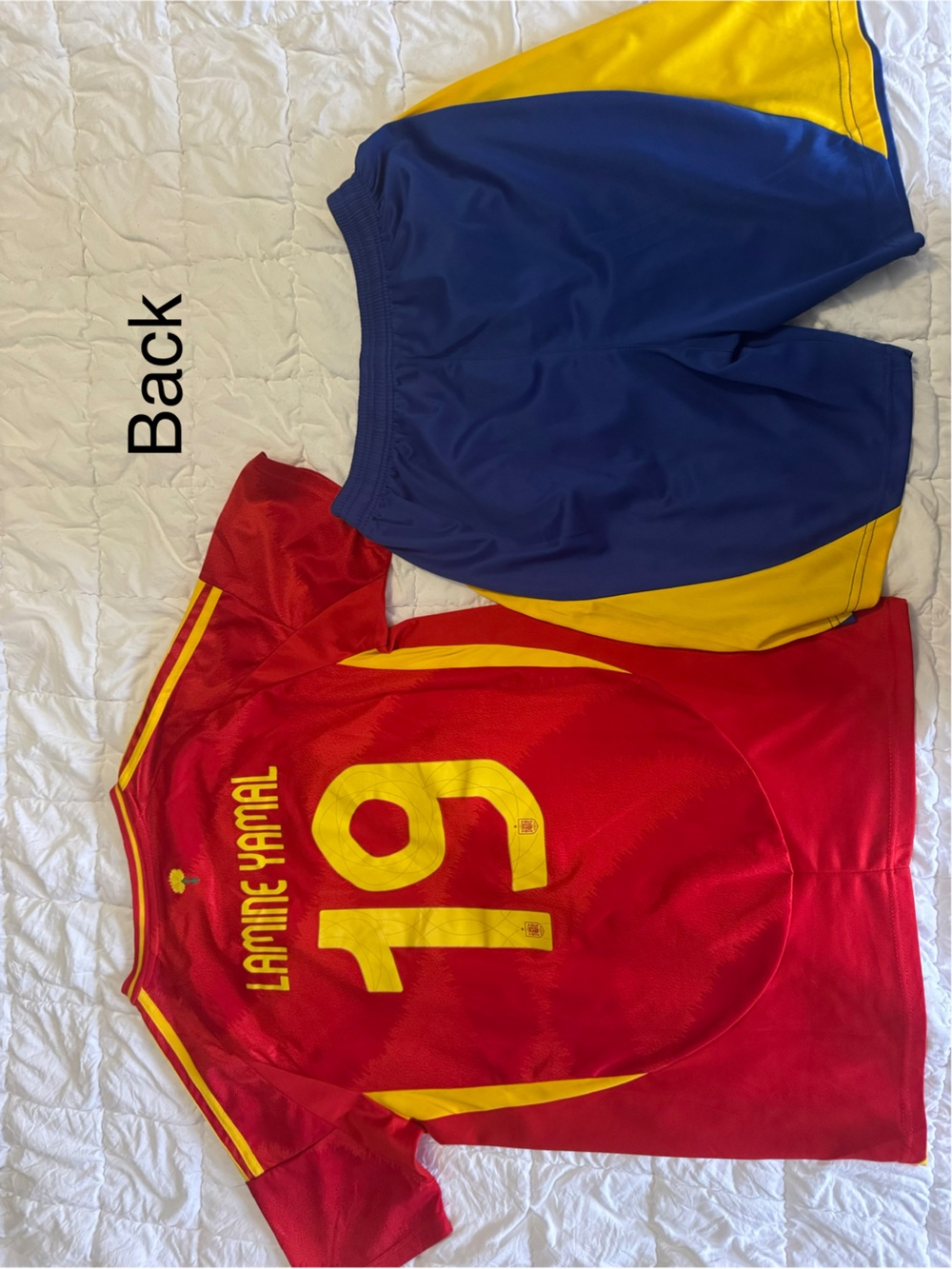 Men's Red Soccer Jersey with Yellow Trim and Blue Shorts